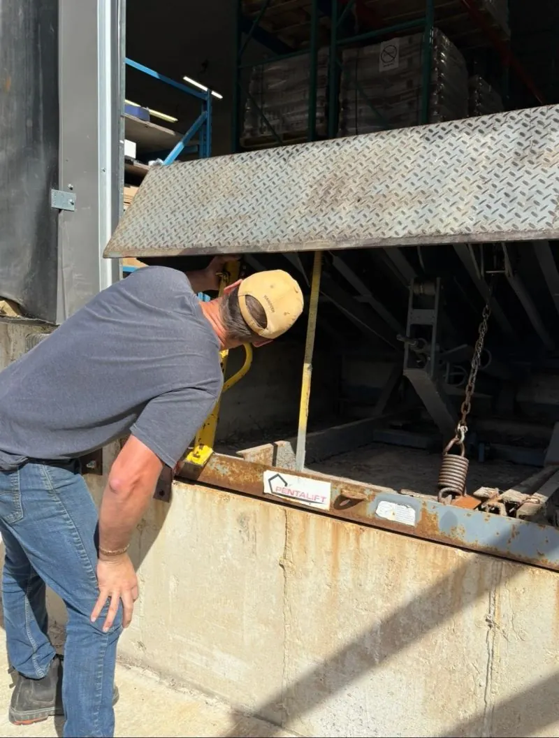 Technician servicing a dock leveler
