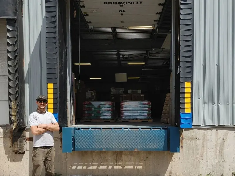 Loading dock with seals, bumpers, and dock leveler